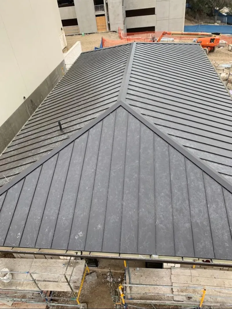 Commercial metal roof construction with crane equipment in Fort Bliss