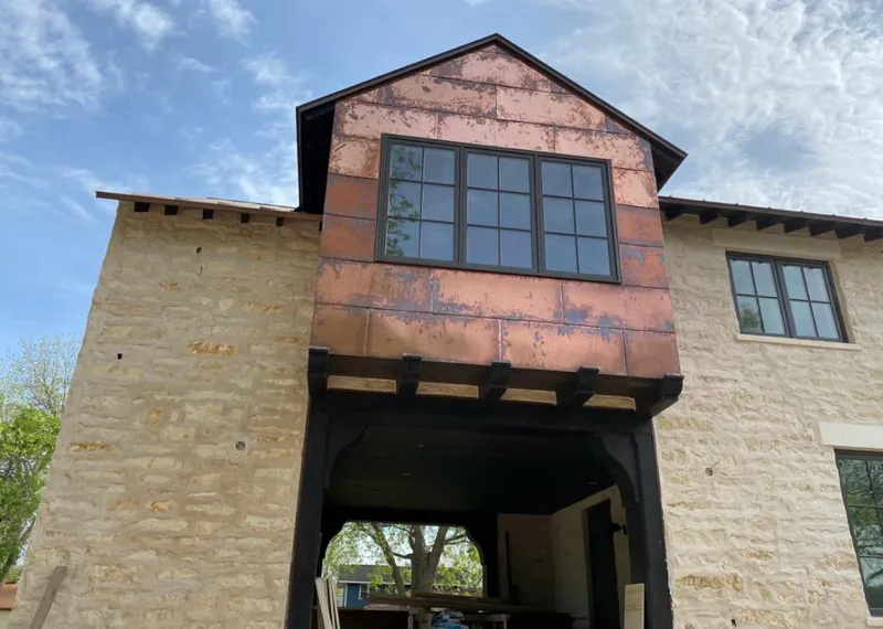 Copper metal panel facade on a stone building for Skylight Installation in Fort Bliss
